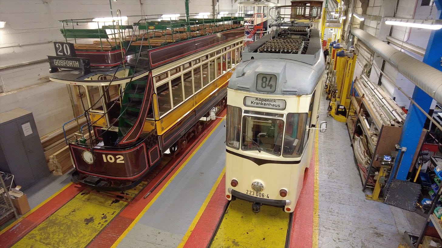 Two trams in the Crich Tramway Village workshop undergoing maintenance. Image: Roland's Travels