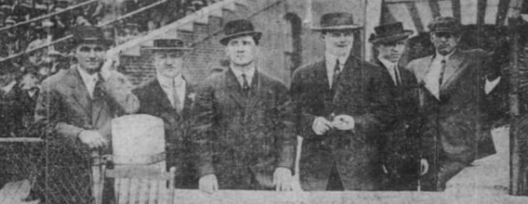The striking players pose for a photo in street clothes.