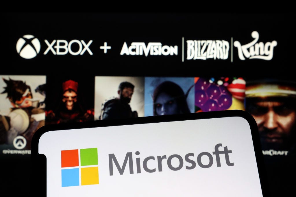 Microsoft logo shown next to logos for Activision games in a photo illustration. (Hakan Nural / Getty Images)