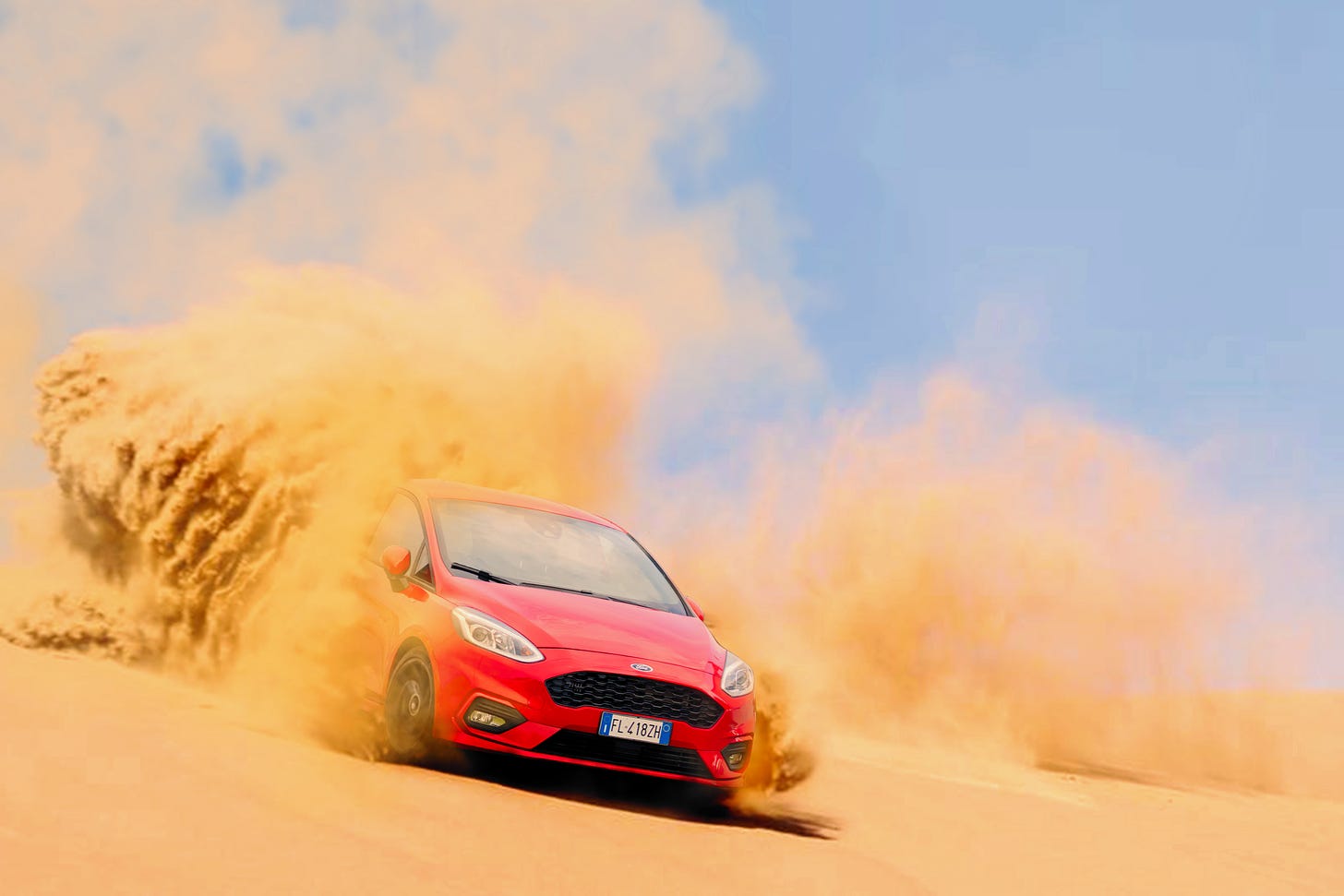 Free Red Ford Focus Vehicle Driving on Sand Under Blue Daytime Sky Stock Photo