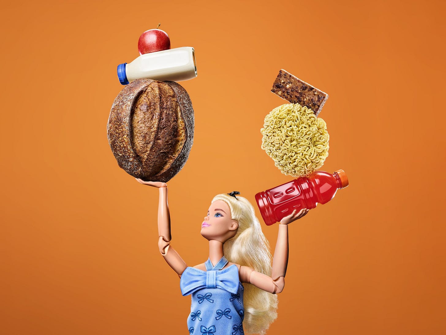 barbie balances groceries in each of her two hands