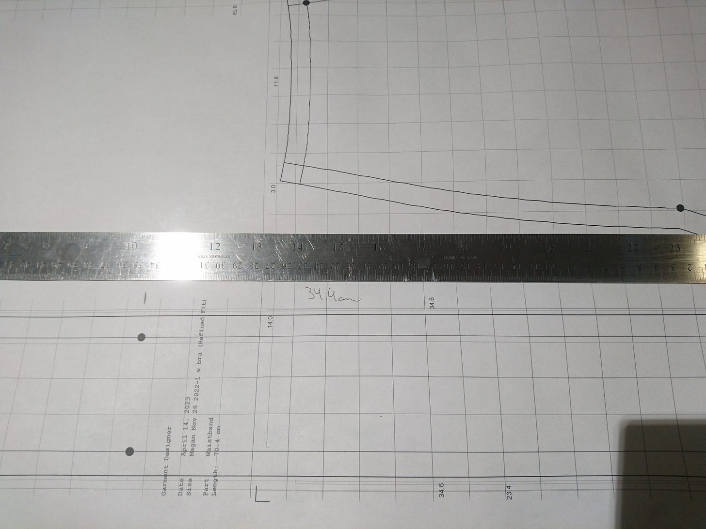 flat patterns with a ruler on top measuring the distance, with hand scrawled notes on top