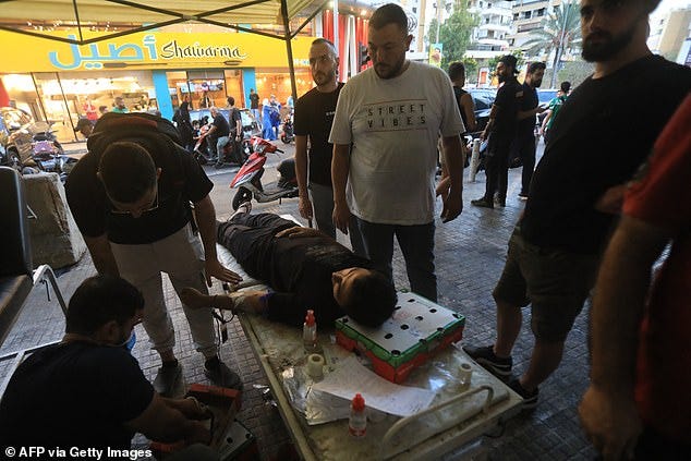 A man donates blood under a tent in Beirut's southern suburb on September 17, 2024 following the series of explosions across Lebanon