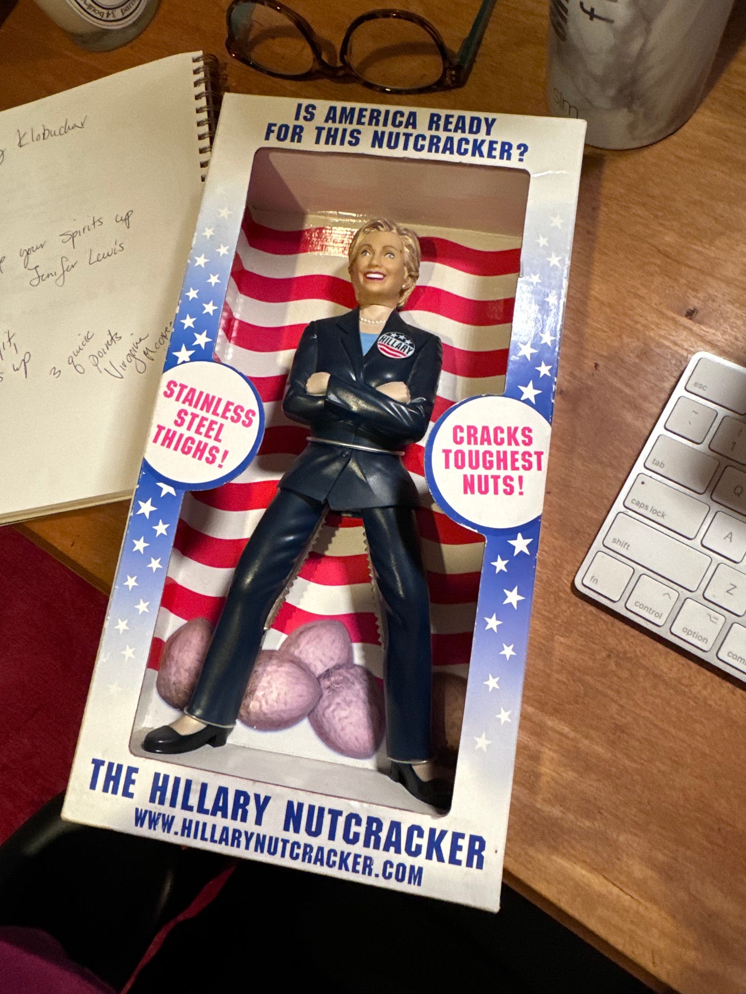 A figurine that cracks nuts, made to look like Hillary Clinton. Text on the box reads "The Hillary Nutcracker," "stainless steel thighs!" "Is America ready for this nutcracker?" 