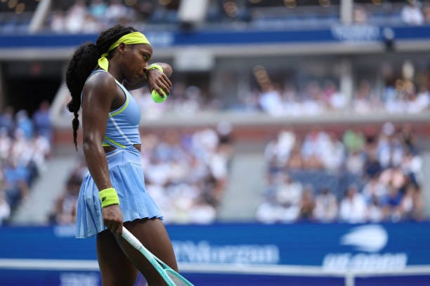 S Coco Gauff wipes her face during her women's singles round of 16 tennis match against USA's Emma Navarro on day seven of the US Open tennis...