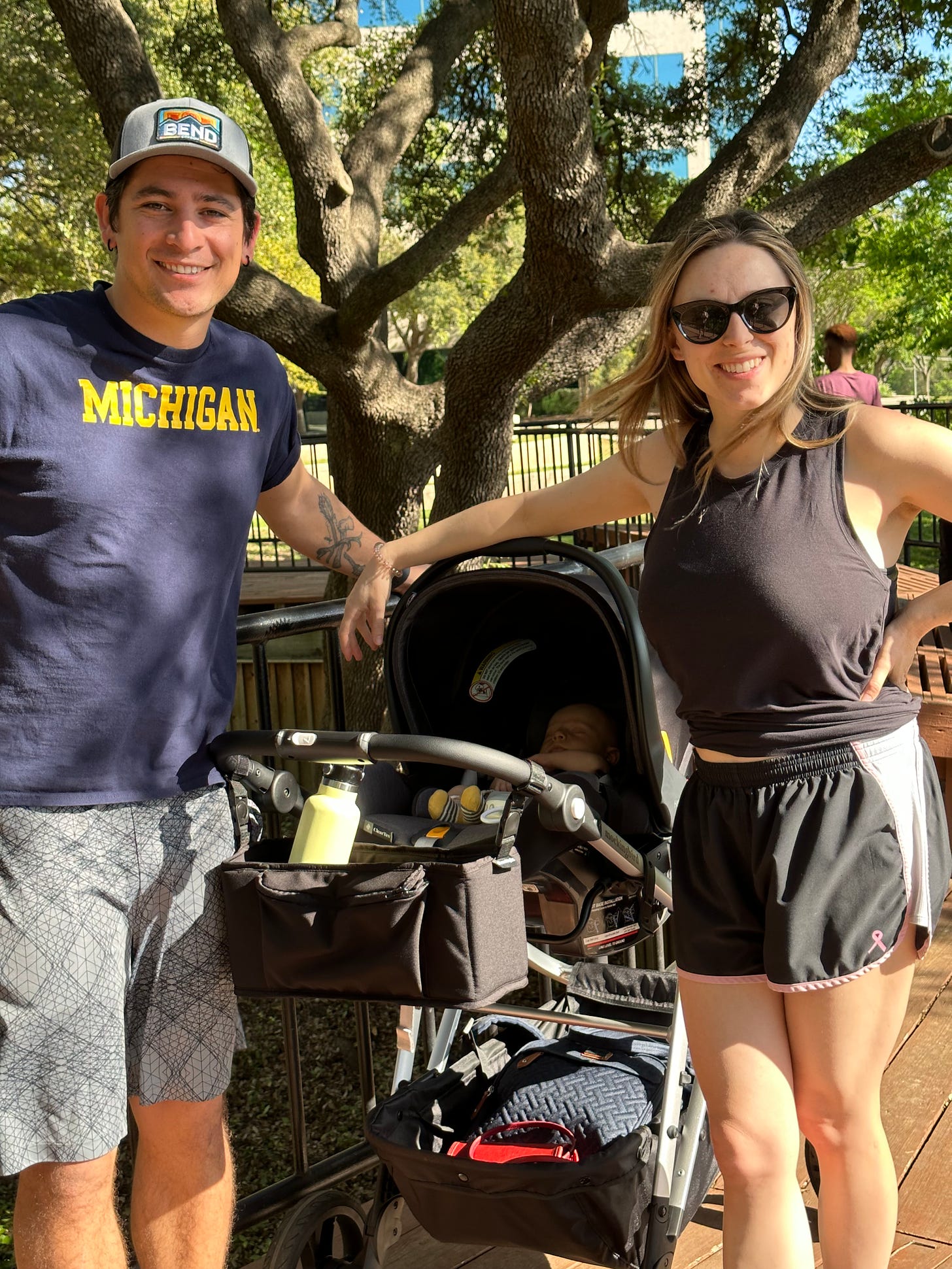 Young couple exercising with baby in stroller