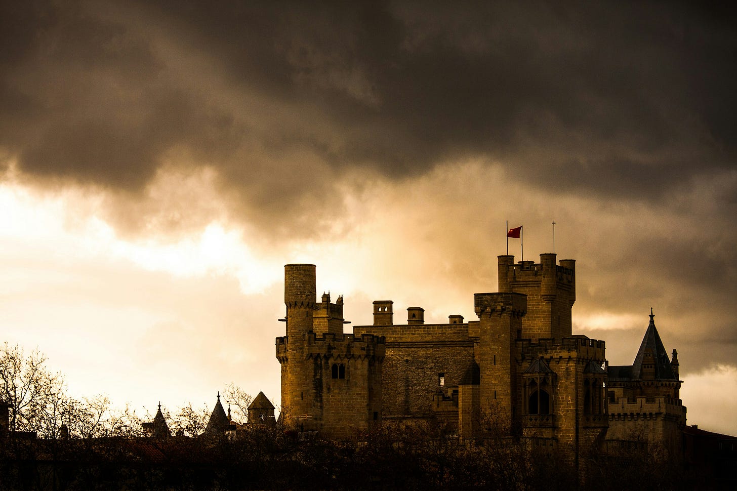 A castle beneath a cloudy sky. 