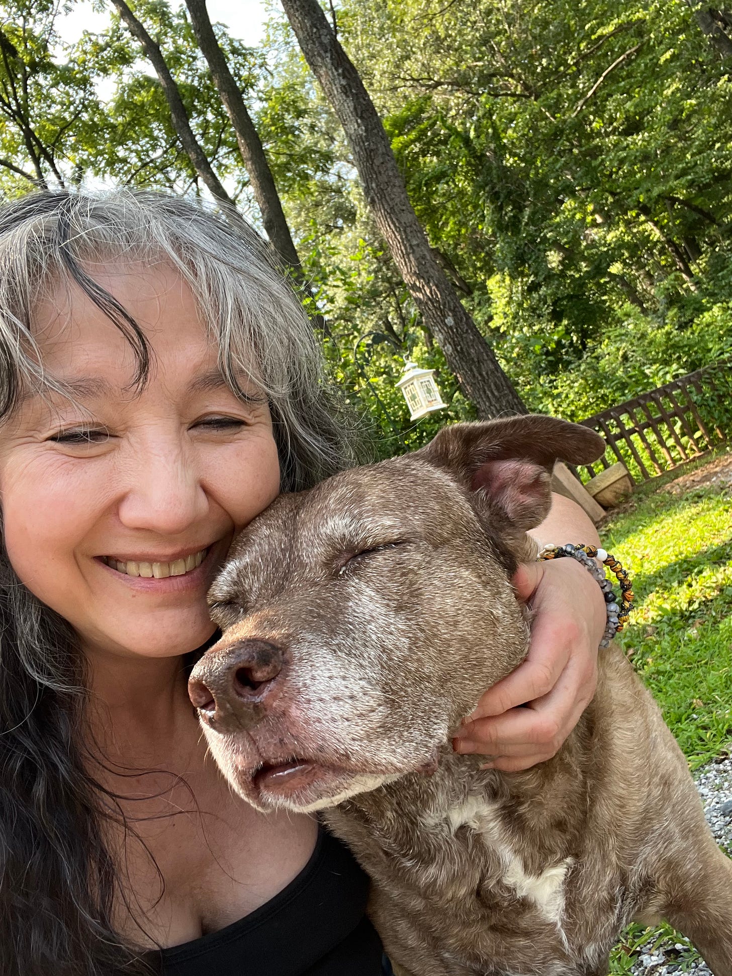 Demian Yumei and her brindle pittie mix. 