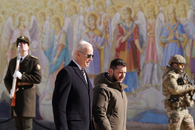 US President Joe Biden (L) walks next to Ukrainian President Volodymyr Zelensky (R) as he arrives for a visit in Kyiv on February 20, 2023.