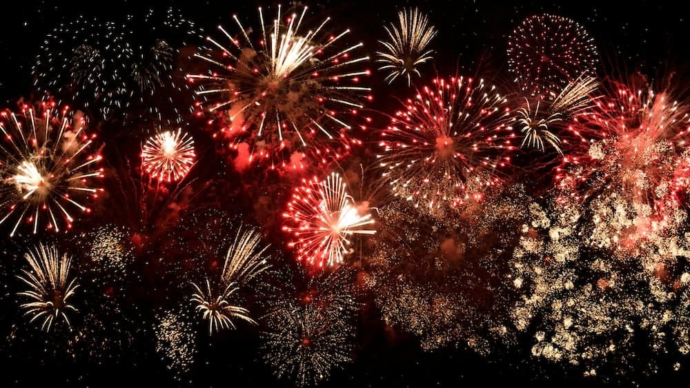 A photo of a large red and yellow fireworks display