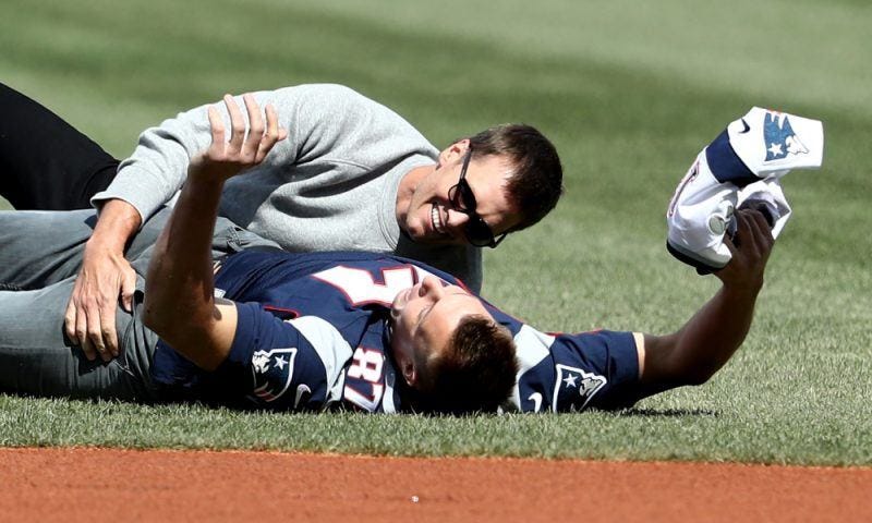 rob gronkowski tom brady rolling around on nfl field