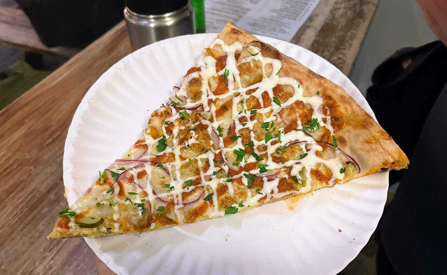 Chicken shawarma pizza on a paper plate