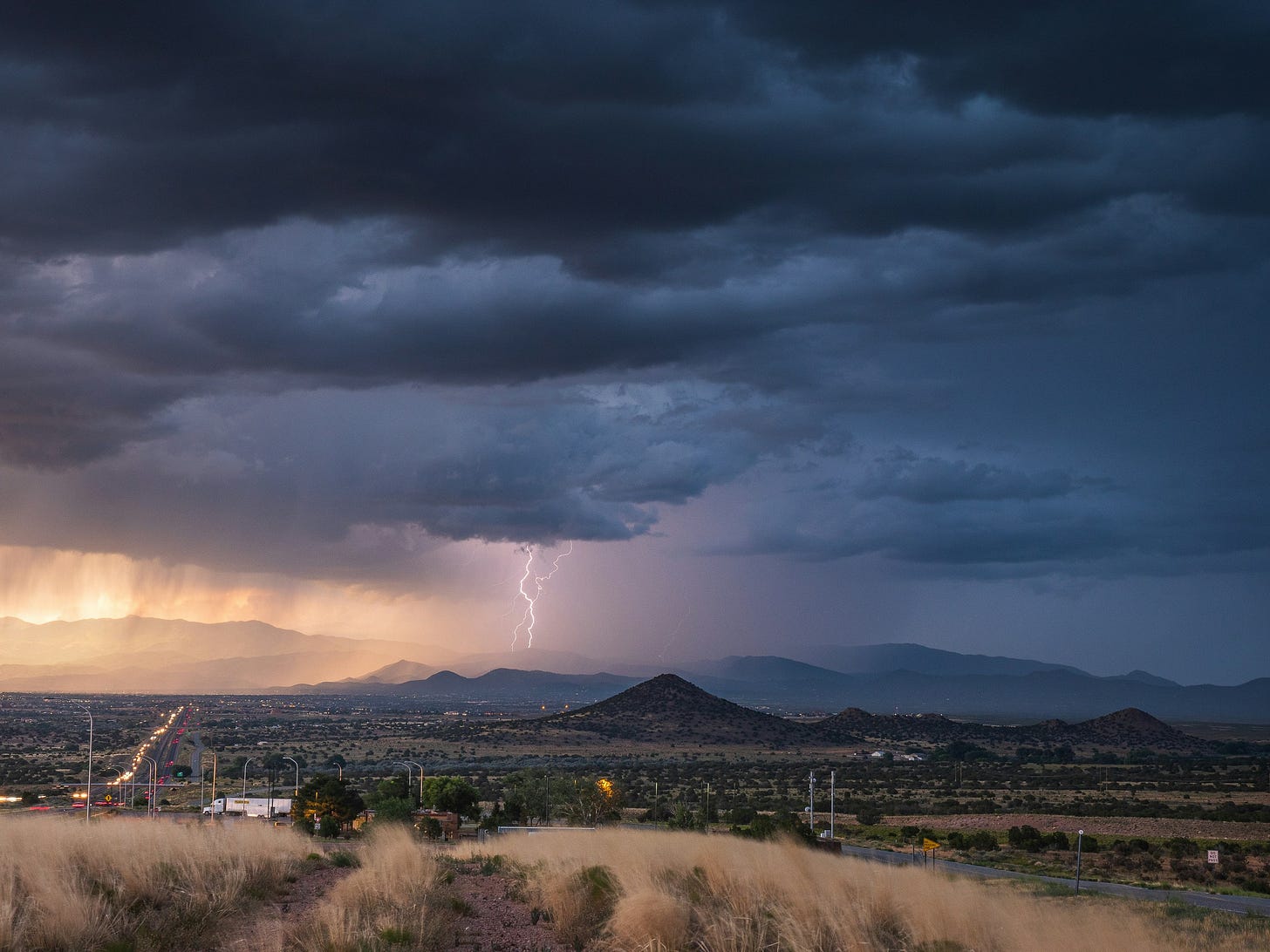 Lightning striking the Santa Fe mountains during monsoon season in New Mexico.