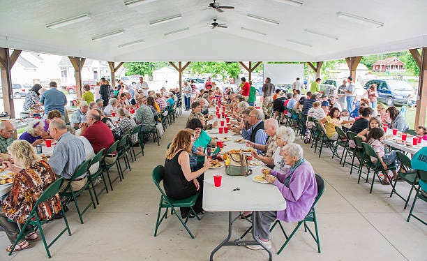 Pitch in Dinner at the Picnic Shelter Helmsburg, USA - June 2, 2013:  Brown County Community Church's Annual Hog Roast attracts many visitors as well a members for a pitch-in dinner in their picnic shelter. small town fun stock pictures, royalty-free photos & images
