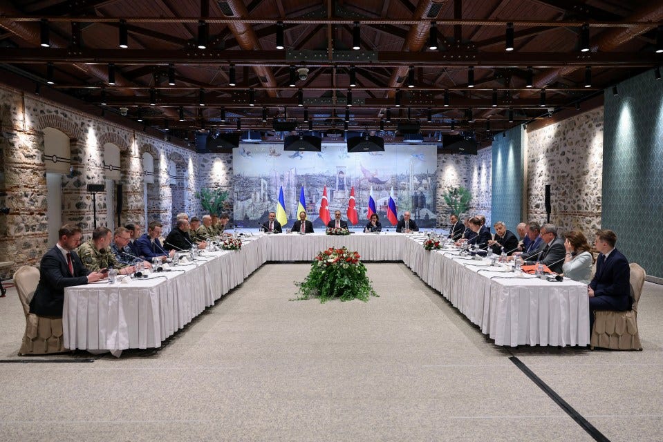 Ukrainian and Russian delegations meeting with Turkish Foreign Minister for peace talks.