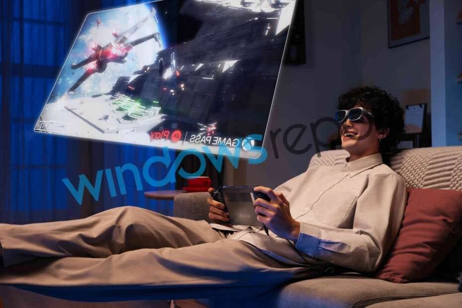 Man playing Lenovo Legion Go wearing AR glasses