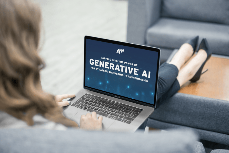 Female marketing executive reading the ANA Generative AI Playbook by CognitivePath