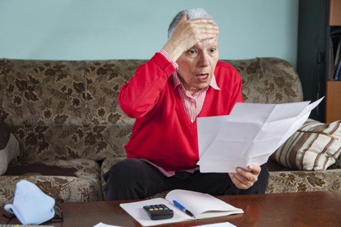 Senior,Old,Woman,Shocked,With,The,Bills,She,Receives,,Appalled