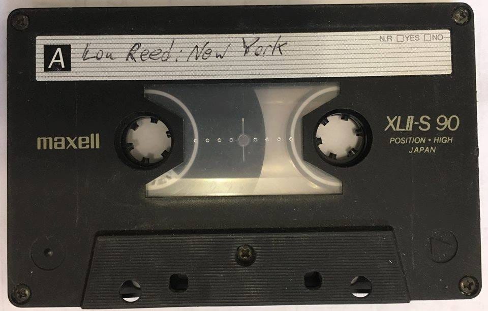 A cassette tape with a label

Description automatically generated