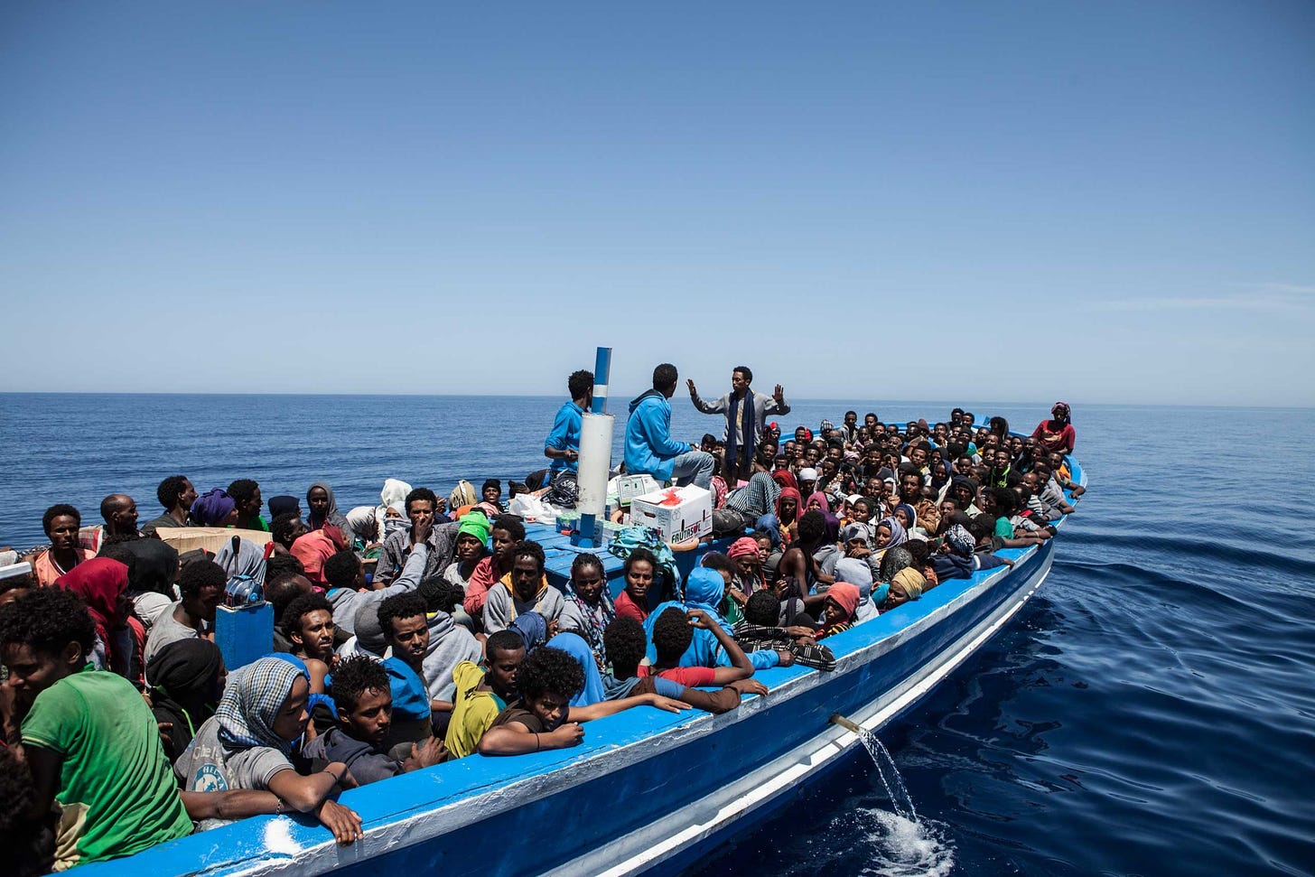 Migrants on a packed wooden boat wait to be rescued off the coast of Malta on May 3, 2015.