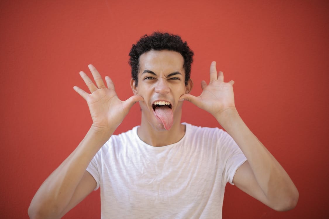Free Happy man funny sticking tongue out Stock Photo