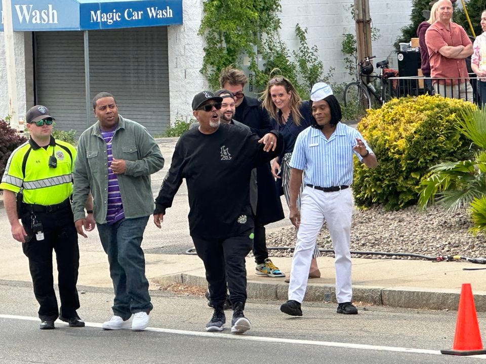 Kenan Thompson and Kel Mitchell cross Mineral Spring Avenue in North Providence, Rhode Island, on Friday, May 19, 2023, with security, to meet fans.