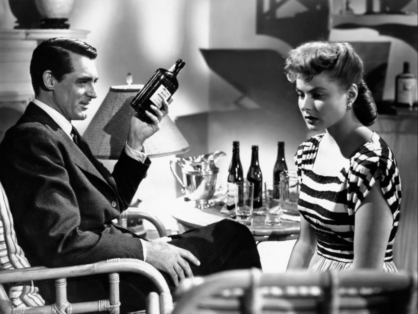 Cary Grant and Ingrid Bergman sitting across from each other, drunk out of their minds
