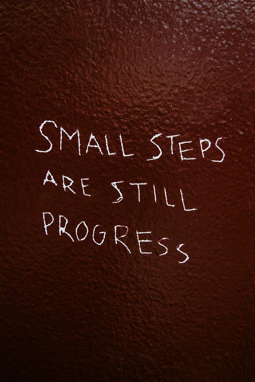 The words in this photo are “SMALL STEPS ARE STILL PROGRESS”.