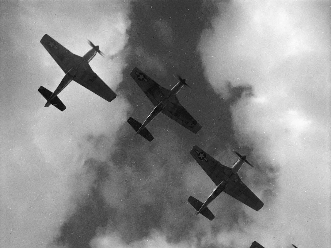 Four P-51 Mustangs flying in formation