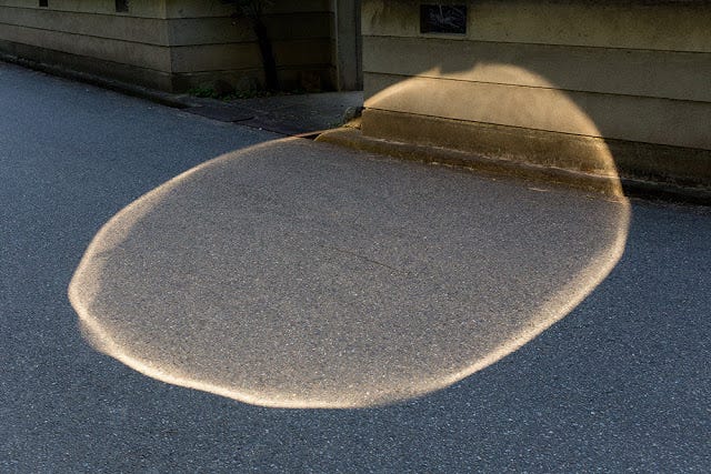 a godlike mysterious circle of light on the pavement