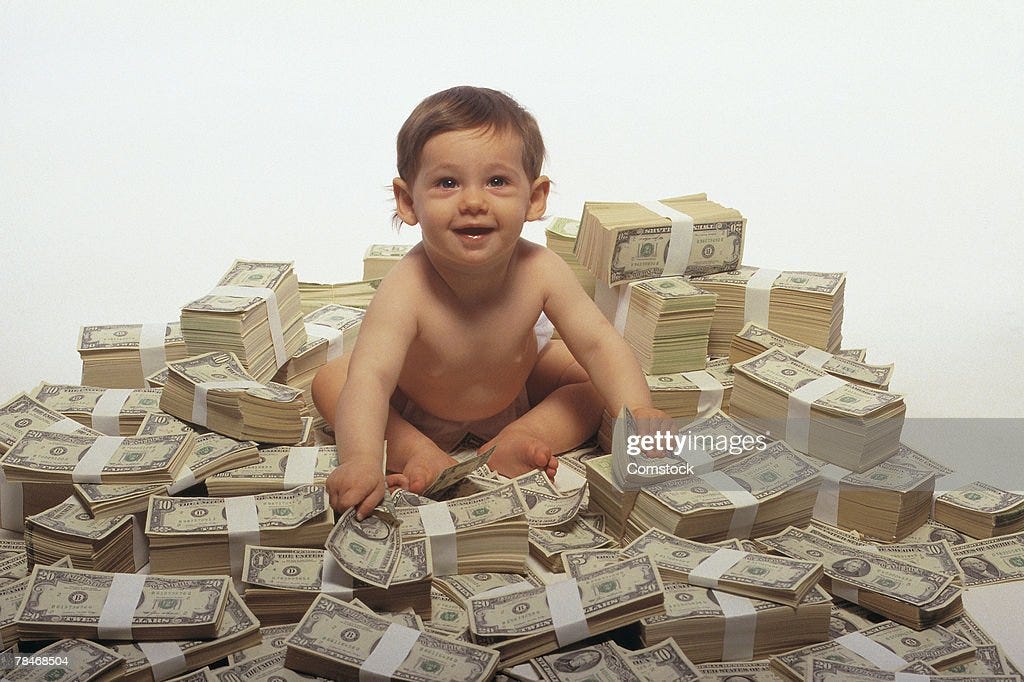 Baby Sitting On Pile Of Money Stock Photo | Getty Images