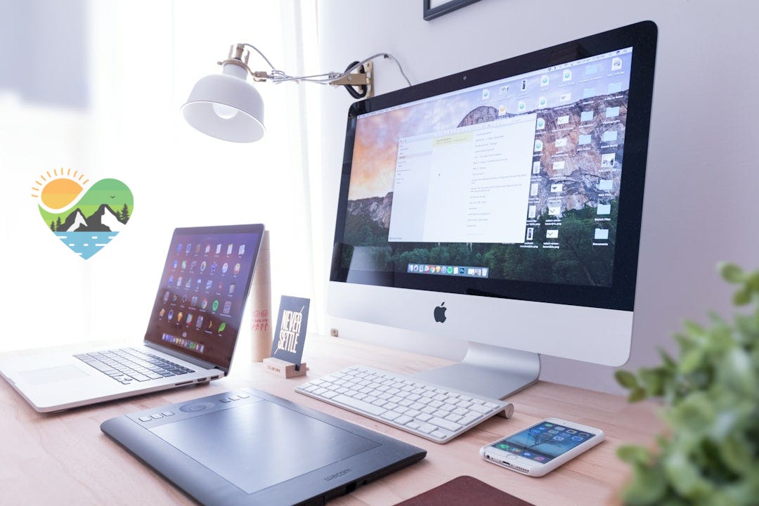 silver iMac near iPhone on brown wooden table