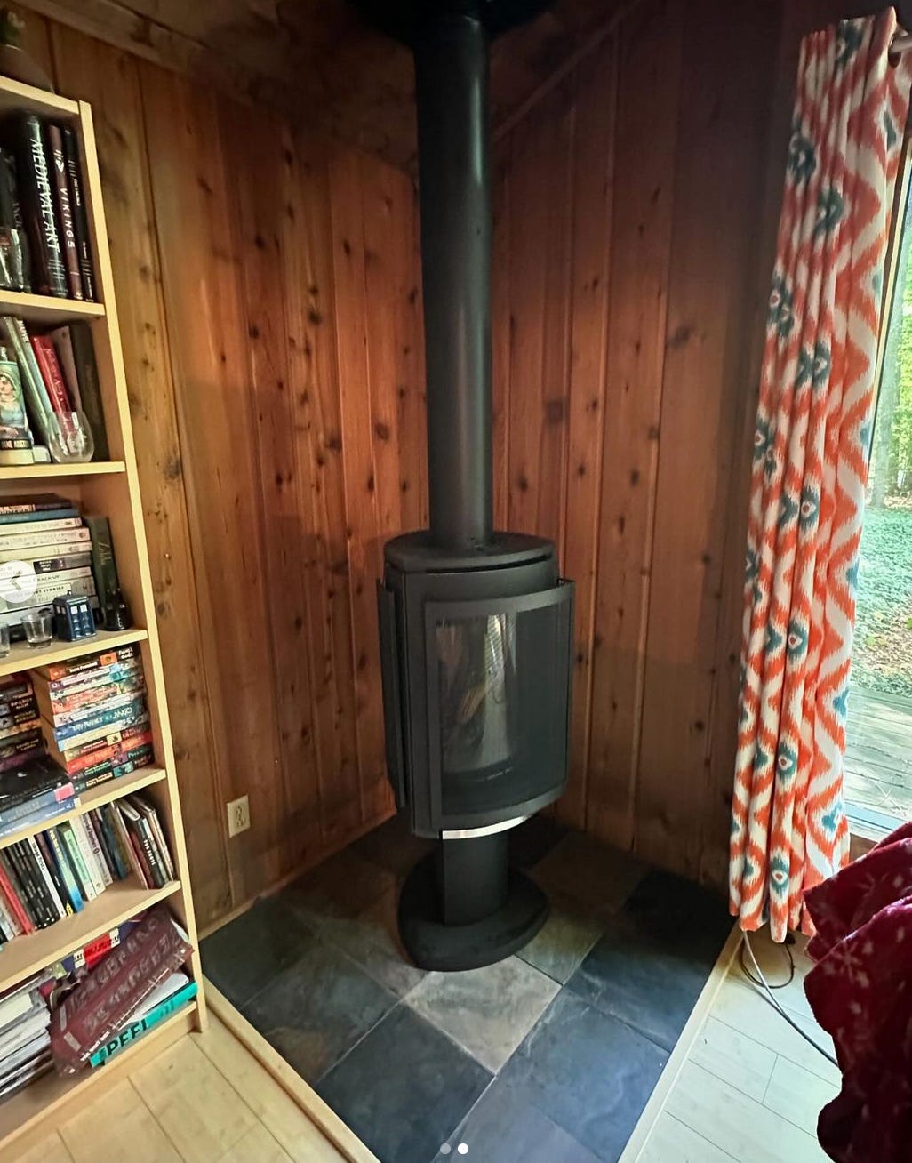 image of a gas stove in a corner with wood paneled walls