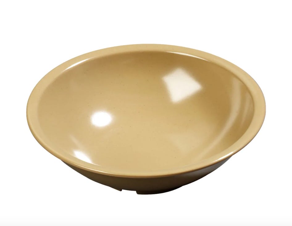 a beige plastic salad bowl