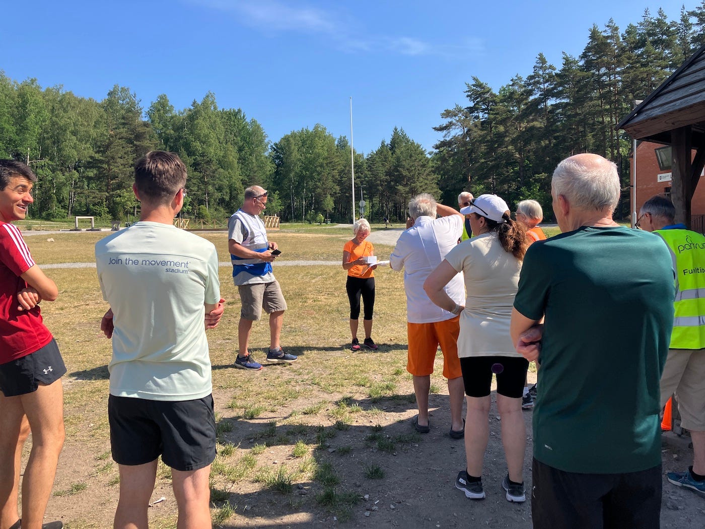 Finishers gather to congratulate a local who has finished her 100th parkrun