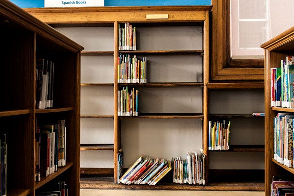 Nearly empty shelves at the Mott Haven branch in the Bronx. While patrons can order books from anywhere in the system, some users say they miss the ability to peruse the stacks.