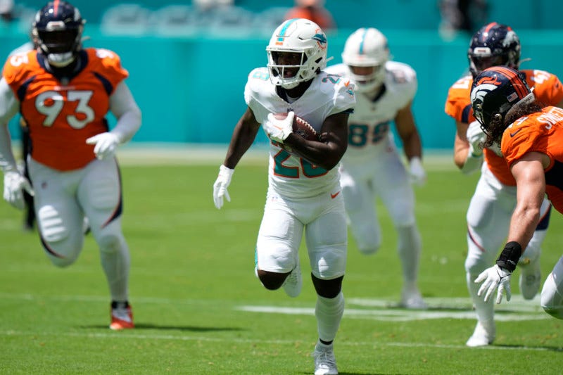 Miami Dolphins running back De'Von Achane (28) runs a play during the first half of an NFL football game against the Denver Broncos, Sunday, Sept. 24, 2023, in Miami Gardens, Fla. (AP Photo/Wilfredo Lee)