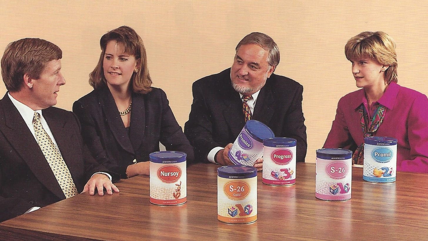 Four businesspeople sitting around a conference table discussing the new labels for their products