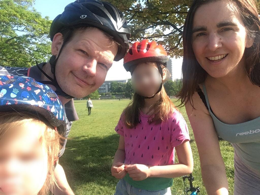 Photo of a family in a park looking sporty