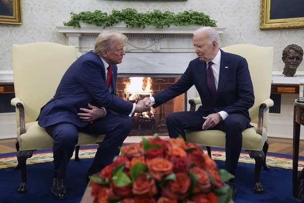 two men shake hands