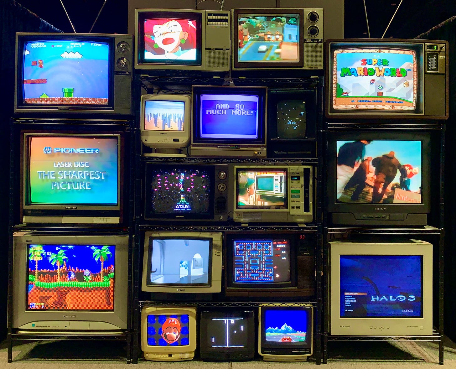 A bunch of old TVs showcasing nostalgic games and shows