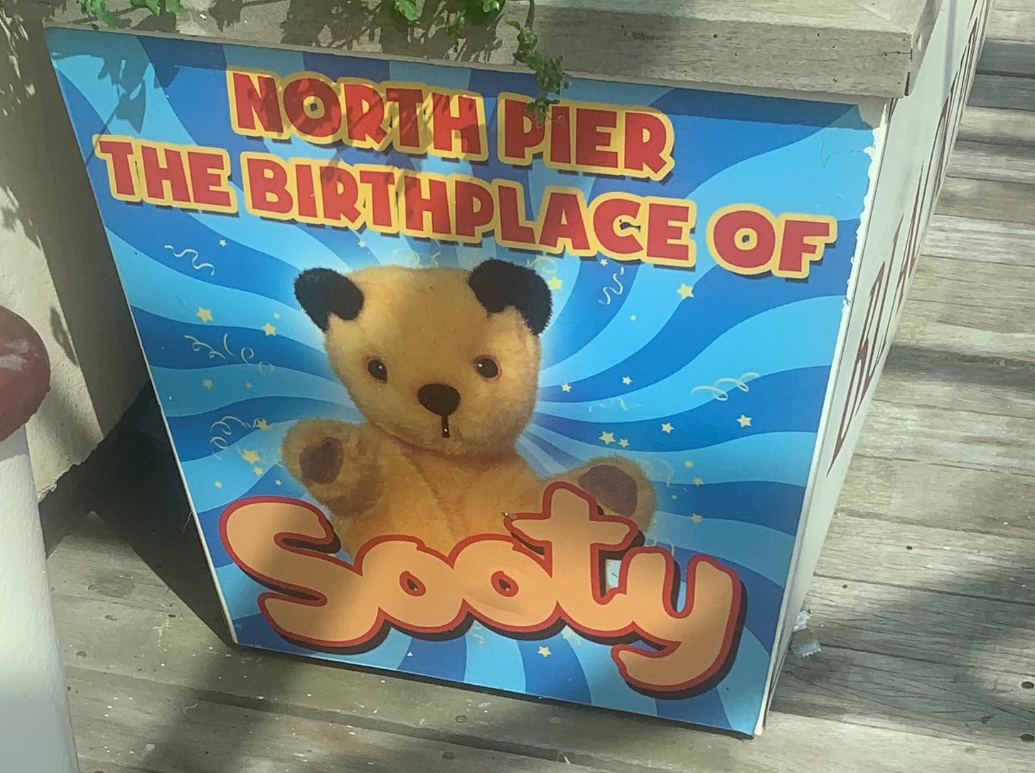 Picture of Sooty with a swirly blue background. Text reads: "North Pier, the birthplace of Sooty"