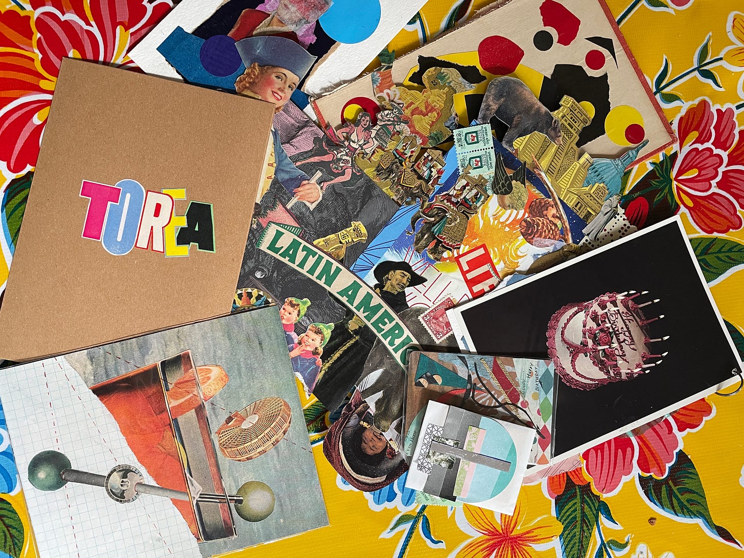 A flat lay photo of art cards covered with colorful collage of many varieties