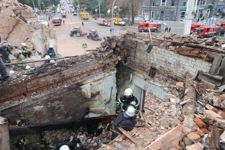 Rescuers search rubble after Russian missile attack in Kharkiv on Friday