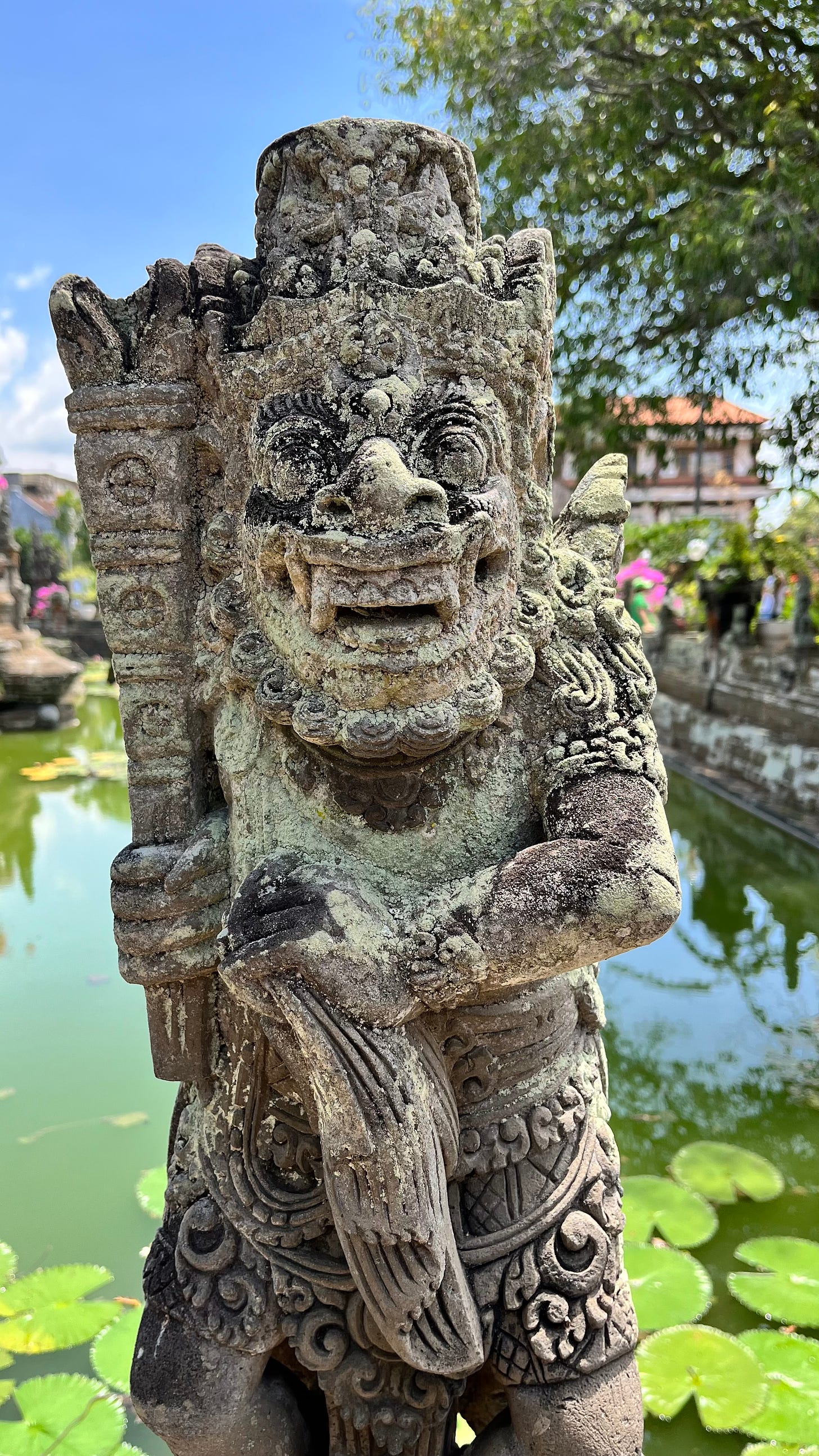 Statue of a Balinese Hindu guardian with weapons in his hands