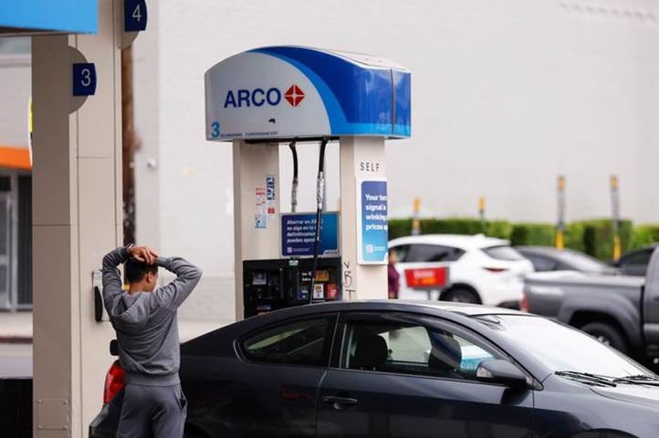 A person standing next to a car

Description automatically generated with medium confidence