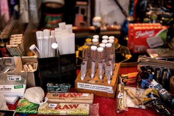 An array of drug paraphernalia for sale on a red shop table.