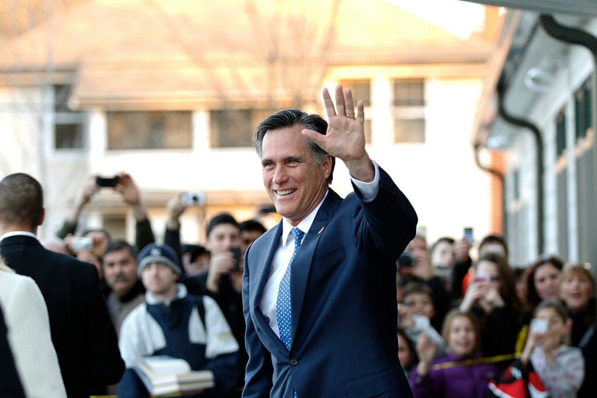 Mitt Romney greeting crowd of people.