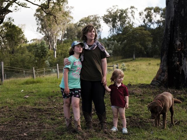 Casey Douglas with her daughters at their property in Nelligen, New South Wales. The lush vegetation can quickly dry out to become kindling.