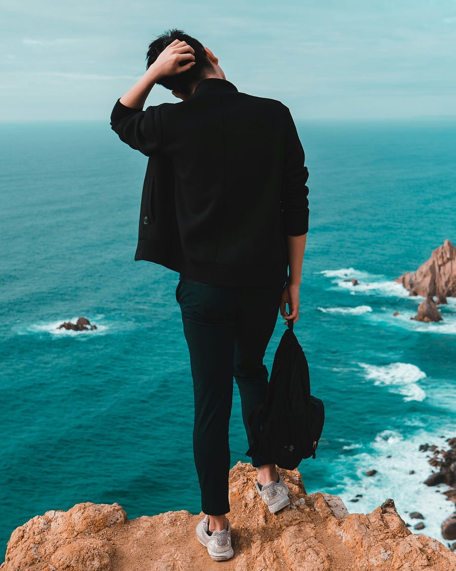A confused man looks out at sea. A confused man looks out at sea.